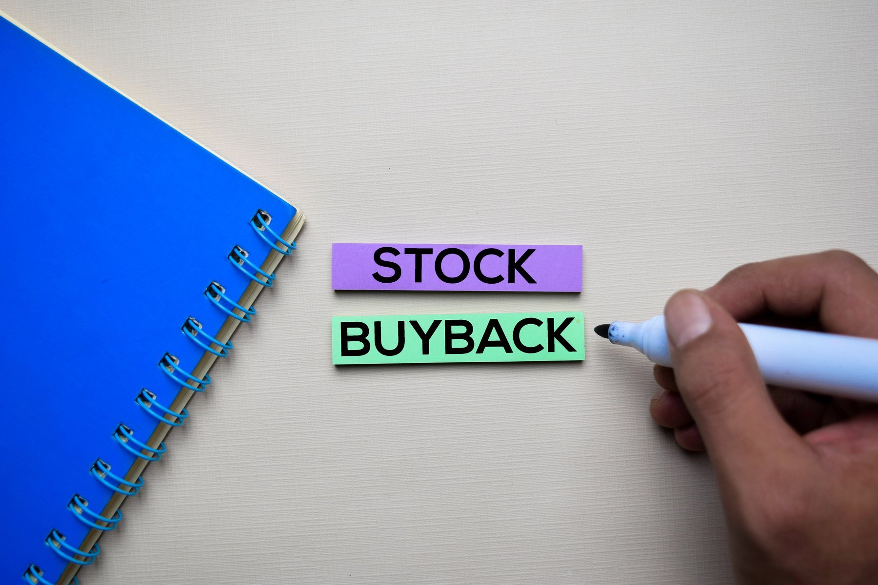 Stock buyback written on a note.